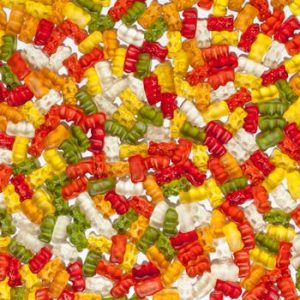 Brightly colored gummy bears in abstract arrangement, perfect for sweet lovers.